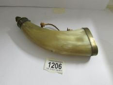 A horn and brass powder flask.