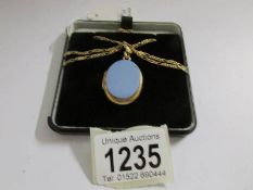 A Victorian oval locket in yellow metal with attached fancy link 9ct gold chain,.