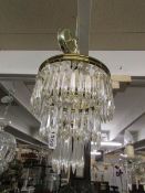A 3 tier crystal glass chandelier.