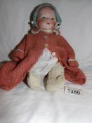 A bisque headed doll marked AM.