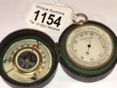 A 19th century cased pocket barometer with compass and ivory scale inside lid (thermometer missing).