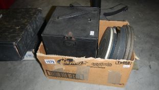 A tin box with 8 x 7" reels of 16 mm black and white films, Titles 'George VI', 'A King's Life',