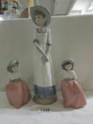 A NAO figure of a young lady and 2 NAO schoolgirls.