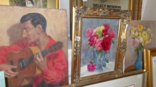 An unframed oil portrait of Spanish musician signed J Ryan, an unframed oil still life painting,