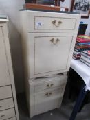 A pair of cream bedside chests.