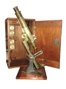 A cased brass microscope marked 'Baker, London'.