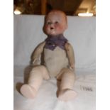 An Armand Marsielle bisque headed doll.