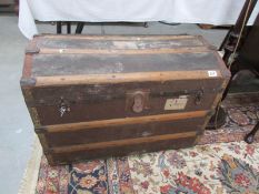 A dome top trunk with tray and featuring luggage labels including LMS railway.