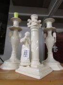 A pair of creamware candlesticks and one other.