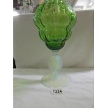 A large green and clear glass goblet.