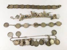A silver charm bracelet, 2 silver coin bracelets and one other.