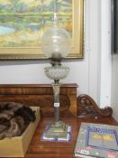 A Victorian silver plated Corinthian column oil lamp.