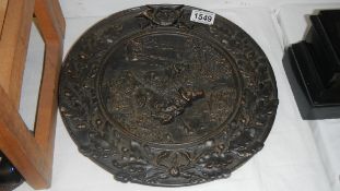 A late 19th / early 20th century pewter wall plaque depicting hunting dogs.