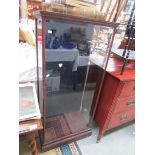 An old shop display cabinet with back opening door.
