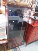 An old shop display cabinet with back opening door.
