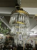 A 3 tier crystal glass chandelier.