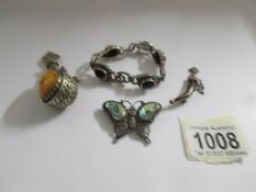 A silver bracelet, a white metal dagger brooch,