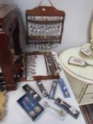 A mixed lot of souvenir spoons and 2 spoon racks.