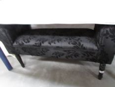 A black upholstered stool.