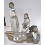 3 NAO figures being boy carrying books, girls petting a puppy and a girl in reclining position.