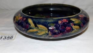 A Moorcroft pomegranate pattern bowl signed William Moorcroft.
