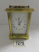 A brass carriage clock with movement marked '7 jewels.