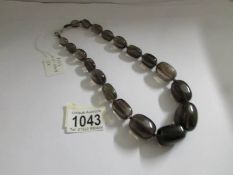 A graduated smoky quartz bead necklace,.