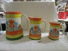 A set of 3 graduated pottery jugs.