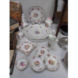 An assortment of 10 pieces of floral decorated china,