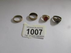 4 gold rings including wedding bands.