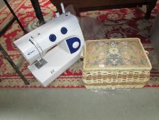 A Delta sewing machine and a sewing box with contents.