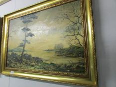 A gilt framed oil on canvas lake scene.