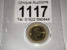 A 1987 1/10 ounce fine gold ten pounds coin.