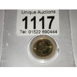 A 1987 1/10 ounce fine gold ten pounds coin.