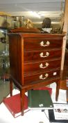 A mahogany 4 drawer music cabinet.