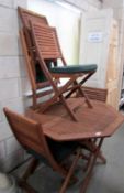 A good quality teak folding garden table and 4 chairs.