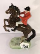 A Beswick rearing horse with huntsman.