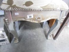 A silver coloured stool,