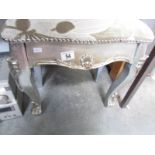 A silver coloured stool,