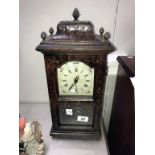 A tall mantel clock.