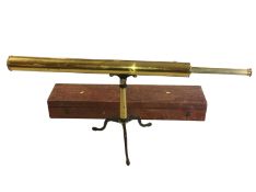 A large cased brass telescope with accessories.