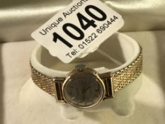 A ladies 9ct gold watch and strap marked on watch face Excalibur Incabloc Swiss Made.