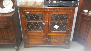 An oak leaded bookcase, glass a/f.