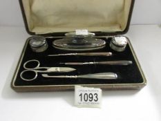 A cased vanity set with silver mounts/fittings.