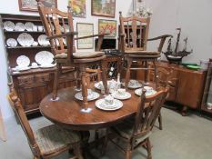 An oval oak dining table and 6 chairs.