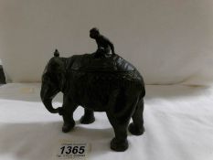 A spelter elephant trinket box with monkey on its back.