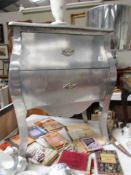 A silver coloured 2 drawer chest.