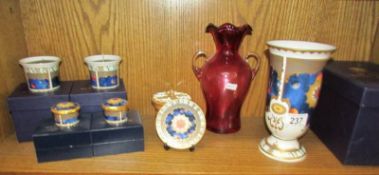 A Royal Worcester vase, trinket pots and candle holders together with a cranberry glass vase,.