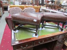 A pair of leather topped foot stools.