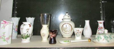 A shelf of vases etc including Portmerion, Wedgwood etc.